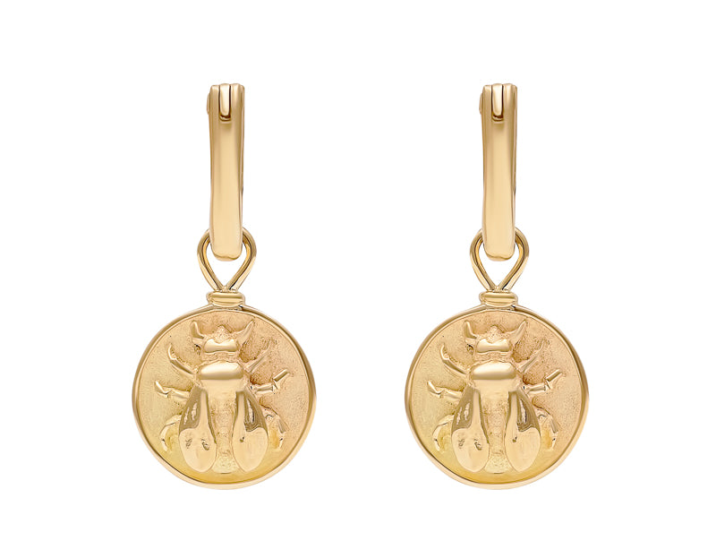 Disk drops in yellow gold with bee carved in relief on face.Drops hang from small U shaped hoops in yellow gold.