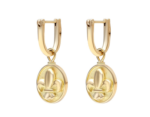 Small round disk drops in yellow gold with fleur de lys carved in relief on face. Drops hang from small U shaped hoops in yellow gold.