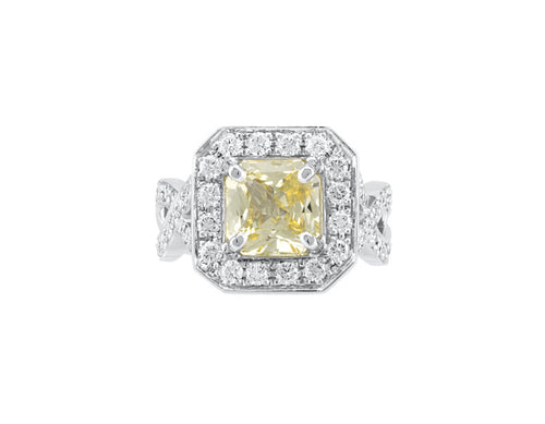 Yellow sapphire ring, platinum, surrounded by diamonds.