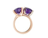Bright purple oval amethyst ring prong set in rose gold together with similar ring in white gold.