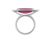 Long cabochon of rich pink tourmaline coming to point at both ends, set in frame of 18 karat white gold with two accent diamonds in frame.