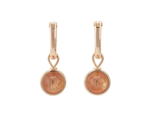 Round drops with bright orange cabochon gem in rose gold frame. Drops hang on small U shaped hoops in solid rose gold.
