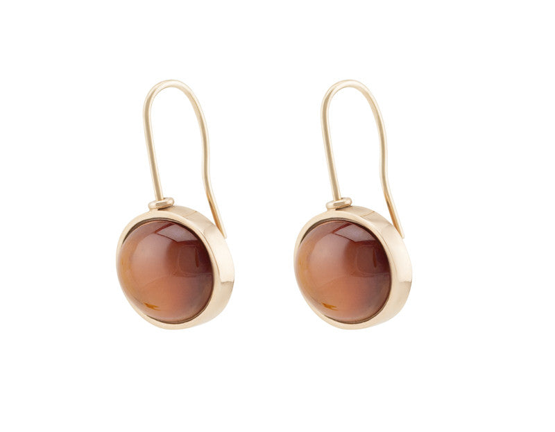 Medium oval orange spessartite garnet cabochons in rose gold frame and shepherd's hooks.