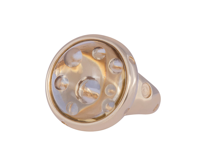 Big yellow gold ring with large round cabochon of citrine. The citrine has bubbles carved into it, and the ring has polka dots carved into it.