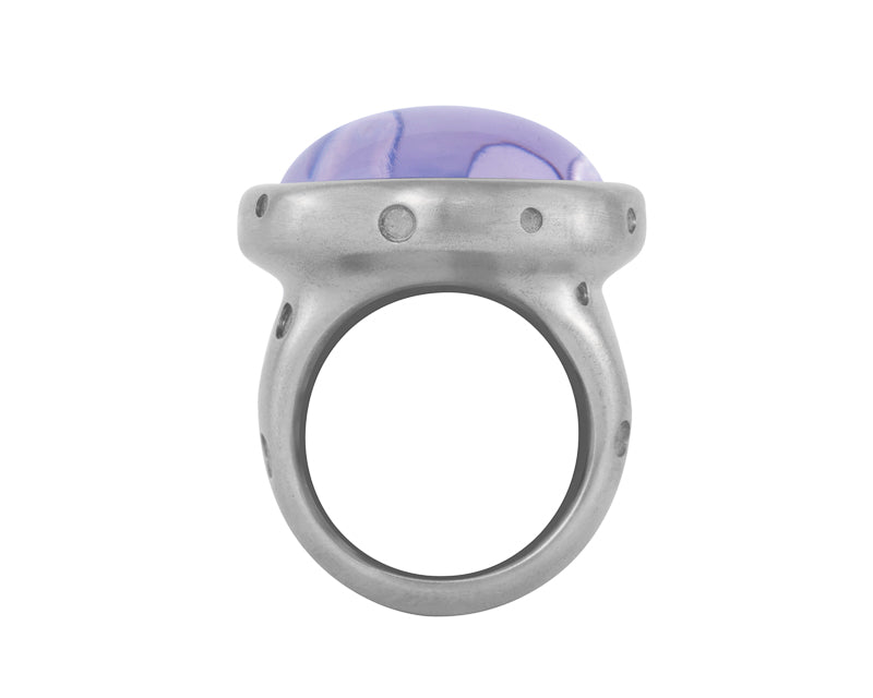 Big white gold ring with large round cabochon of amethyst. The amethyst has bubbles carved into it and polka dots carved into the ring.