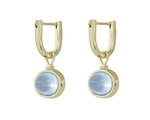 Oval drops with light blue cabochon gem in green gold frame. Drops hang on small U shaped hoops in solid green gold.