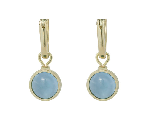 Round drops with light blue cabochon gem in green gold frame. Drops hang on small U shaped hoops in solid green gold.