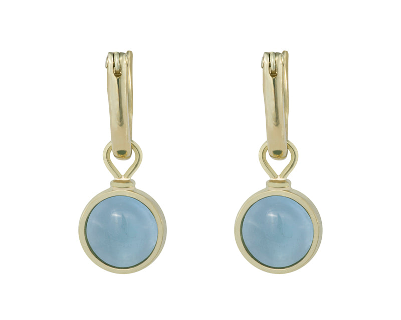 Round drops with light blue cabochon gem in green gold frame. Drops hang on small U shaped hoops in solid green gold.