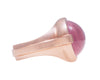 Large rose gold ring with overlapping ribbon of gold around the band set with large oval cabochon of rose quartz. Gem lies across the finger.