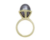 Green gold ring set with pear shaped grey pearl.