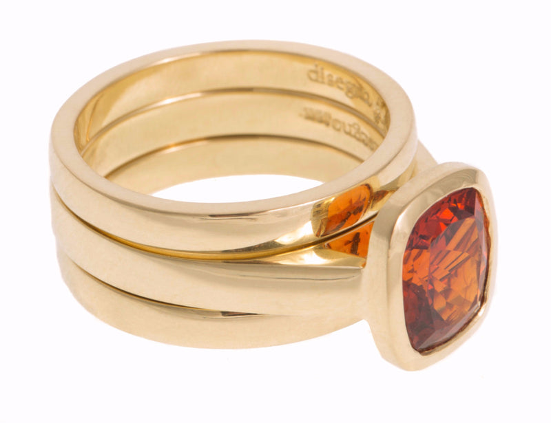Rose gold ring with rectangular deep orange spessartite garnet gem, matching side bands. 