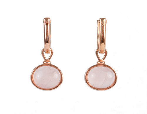 Small oval drops with soft pink cabochon gem in rose gold frame.  Drops hang from small U shaped hoops in rose gold.