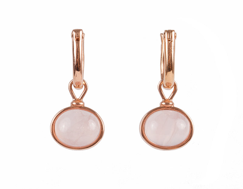 Small oval drops with soft pink cabochon gem in rose gold frame.  Drops hang from small U shaped hoops in rose gold.