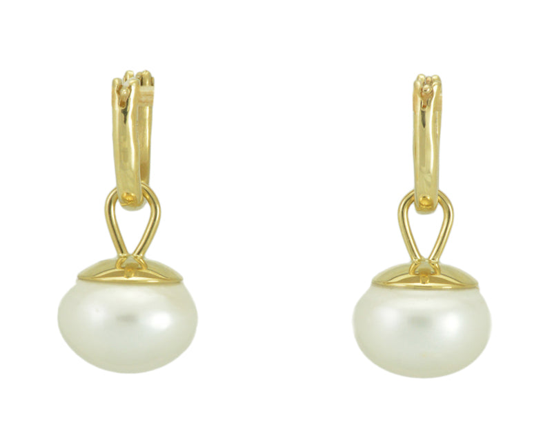 Large oval pearl drops with yellow gold cap. Drops hang from small U shaped hoops in yellow gold.