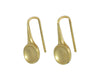 Oval drop earrings in yellow gold with matte finish in bowl, on shepherd's hooks.