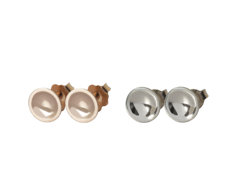 Two pairs small round stud earrings in rose gold and white gold with matte finish in bowl.