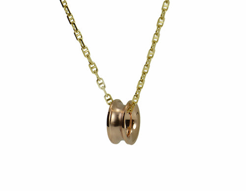 Rose gold bead shaped like spool of thread, on yellow gold chain