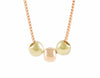 Three round beads in rose and green gold on chain.