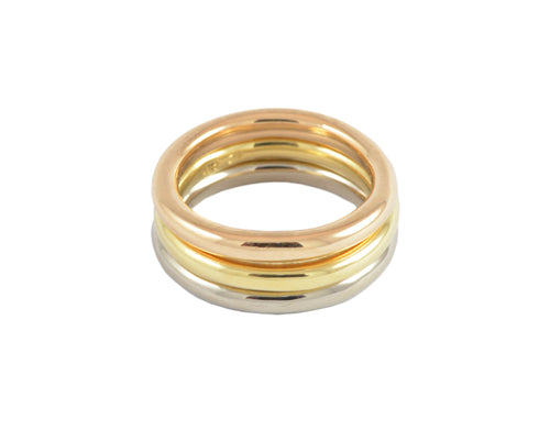 Set of three round bands in rose, yellow and white gold.