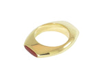 Solid gold ring, with oval face on top and bottom with red and black gems.