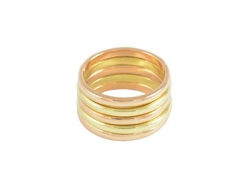 Stack of five thin narrow bands in rose and green gold.
