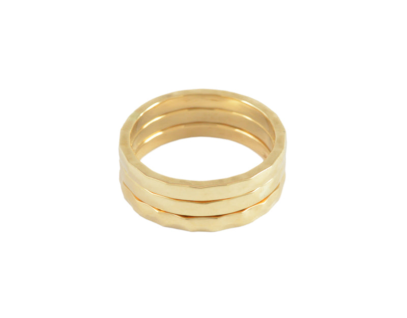 Set of three thin hammered bands in yellow gold.