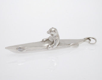 Sterling silver sculpted polar bear in kayak pendant.