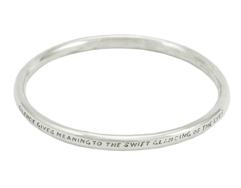 Silver bangle, round wire, with engraved text.