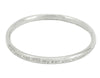 Silver bangle, round wire, with engraved text.