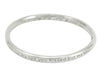 Silver bangle, round wire, with engraved text.