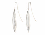 Very long silver drop earrings in the shape of vanilla beans.