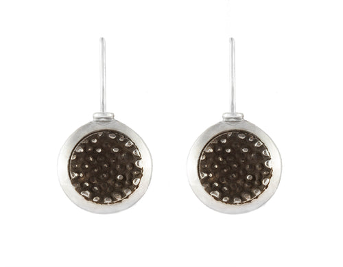 Round silver drop earrings with blackening and granulation in centre.