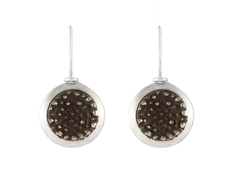 Round silver drop earrings with blackening and granulation in centre.