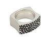 Wide silver band with blackening and texture. Concave sides.