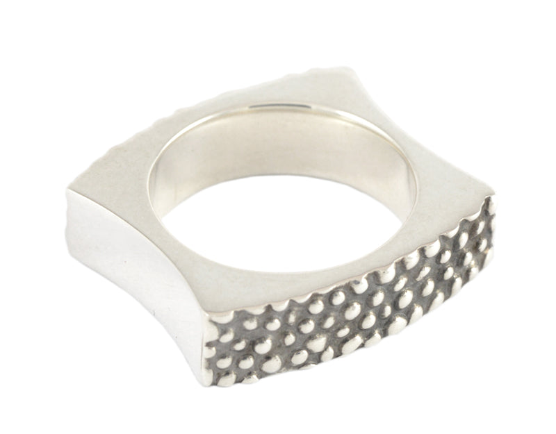 Wide silver band with texture, blackening.