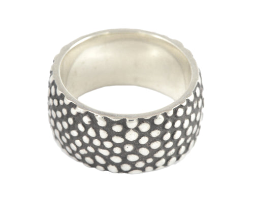 Wide silver band with texture, blackening.
