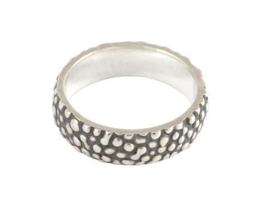 Wide silver band with texture, blackening.
