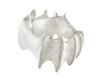 Very large silver ring in shape of vertebrae.