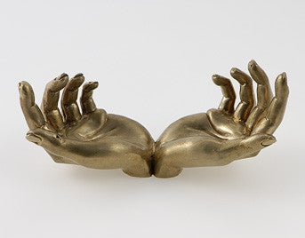 Very detail sculpture of a pair of hands in bronze.