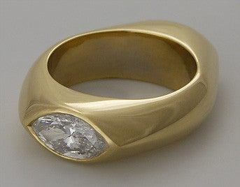 Heavy gold ring with marquise cut diamond.