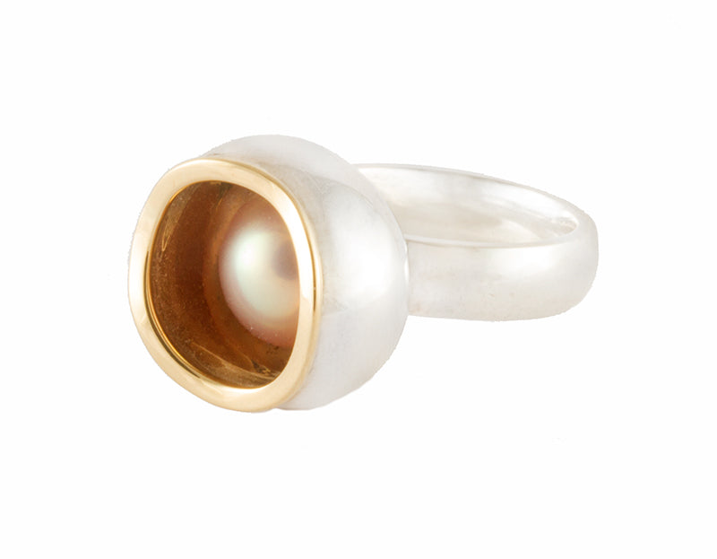 Very large silver ring, large bowl, gold rimmed pearl set inside.