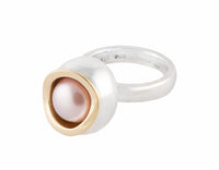 Large silver ring, large bowl, gold rimmed pearl set inside.