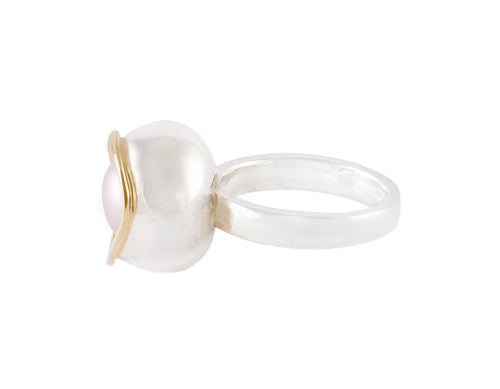 Large silver ring, large bowl, gold rimmed pearl set inside.