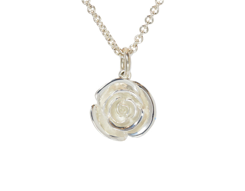 Very large silver carved rose pendant, frosted.  Hung on silver chain.