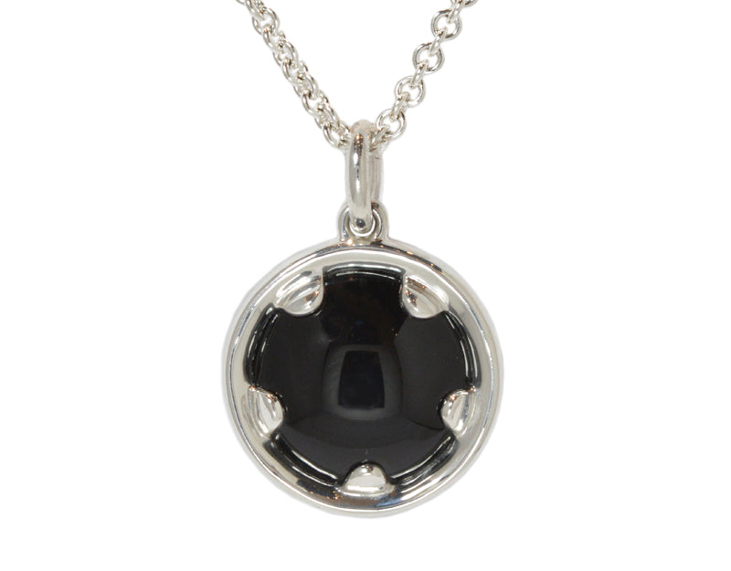 Very large silver pendant with black onyx.  Hung on silver chain.