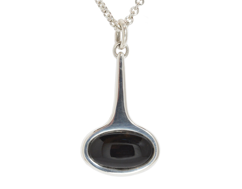Very large silver pendant with black onyx.  Hung on silver chain.