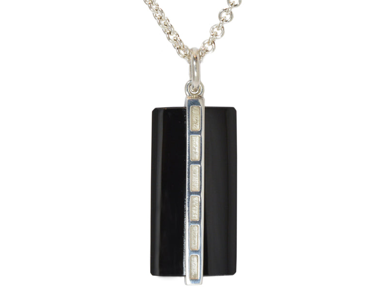 Very large silver pendant with wafer of black onyx.  Hung on silver chain.