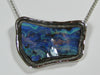 Free form blue opal in white gold pendant.