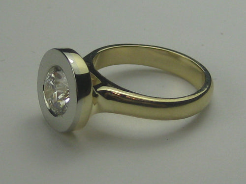 Yellow gold ring with white gold face set with diamond.