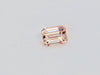 Small rectangular peach-pink sapphire gem, on white background.